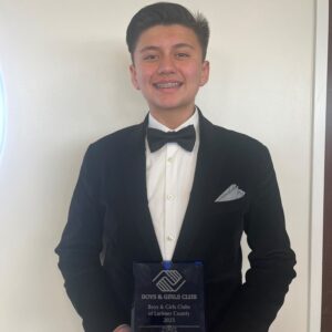 2023 Youth of the Year, Jose, holding his award