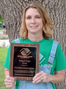 Christine Cunningham posing with the Doing It Wright Award