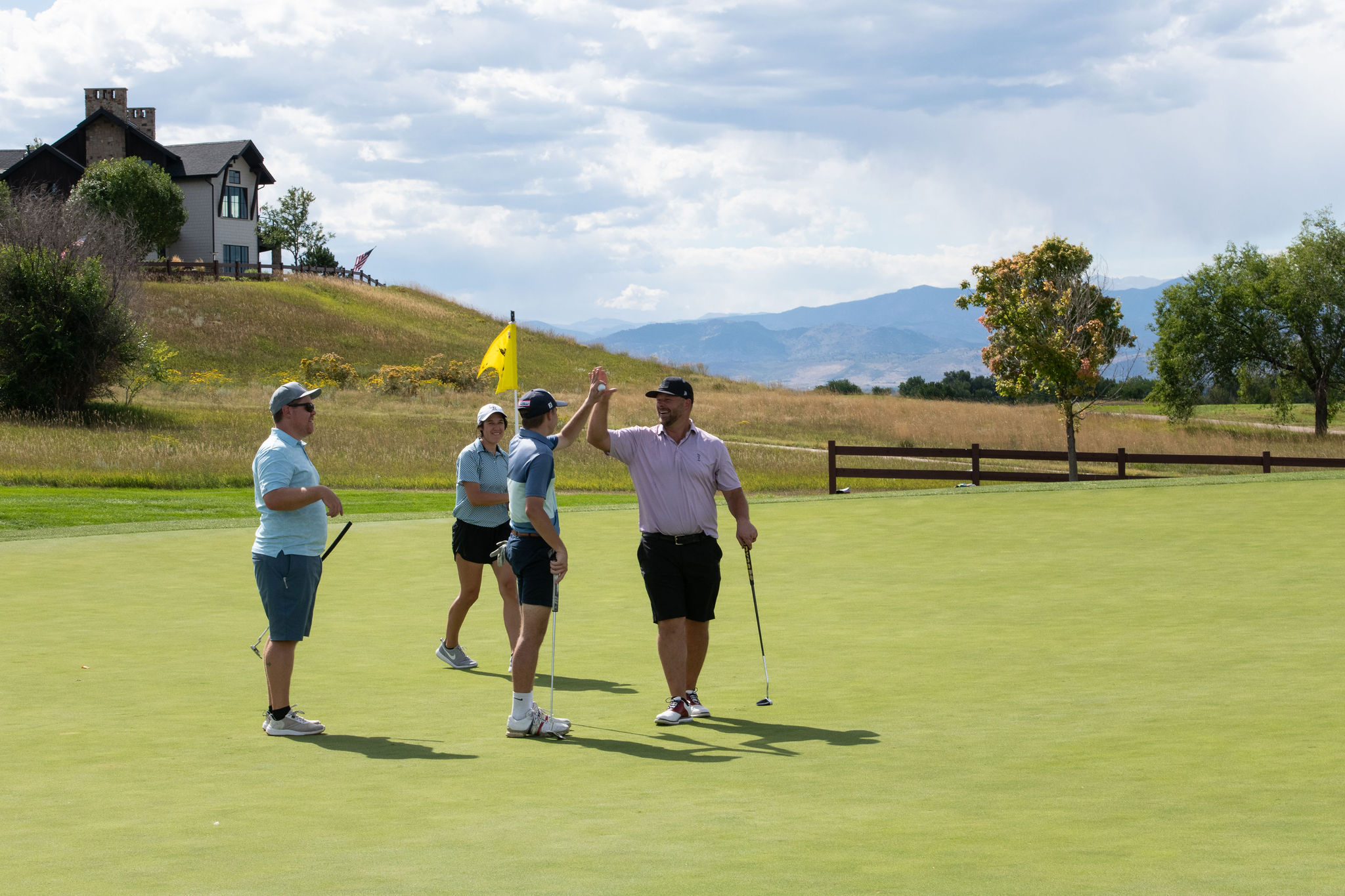 Players congratulating each other at the 2025 Fore the Kids Golf Tournament